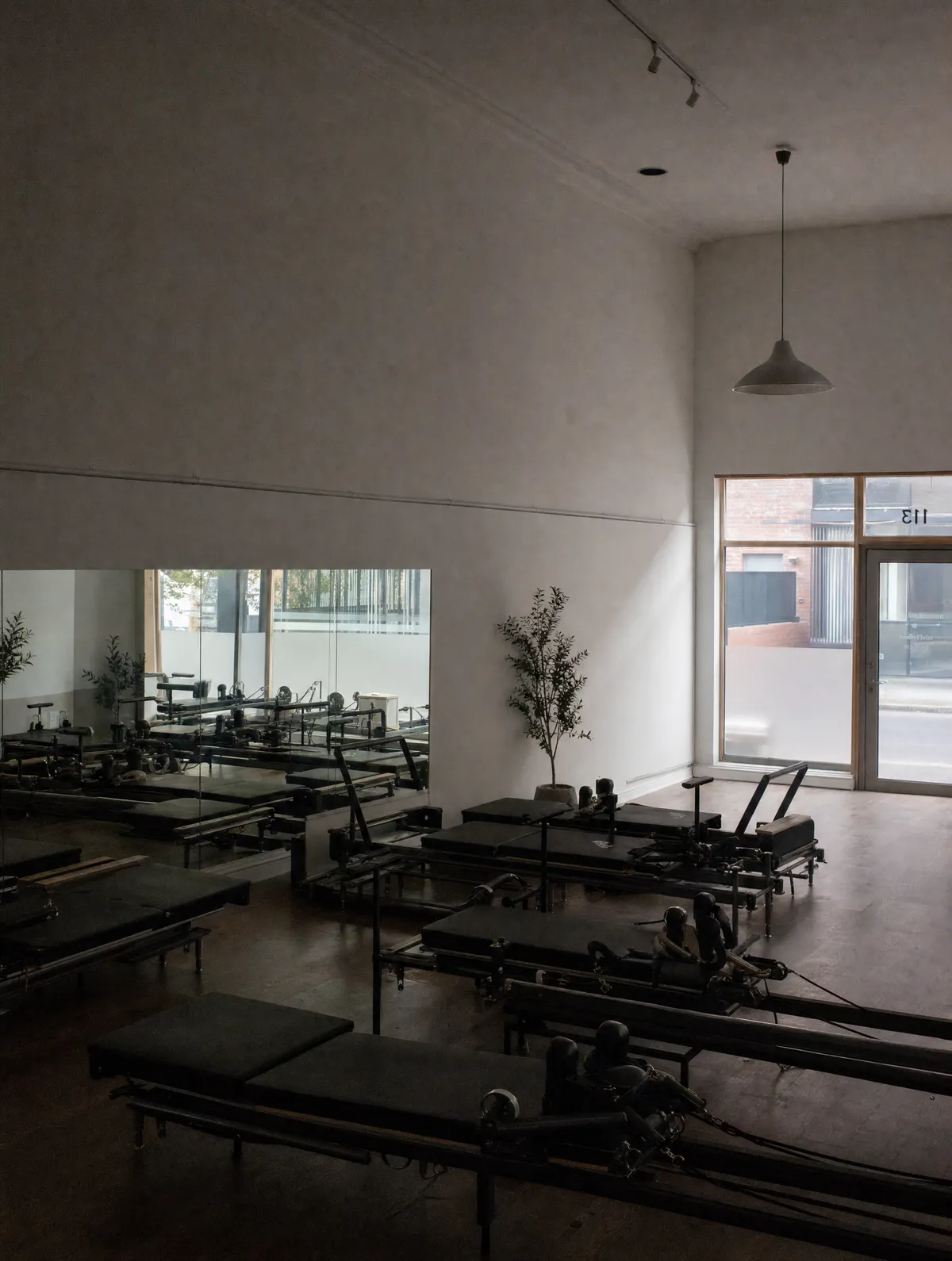 An empty Pilates reformer studio, early in the morning